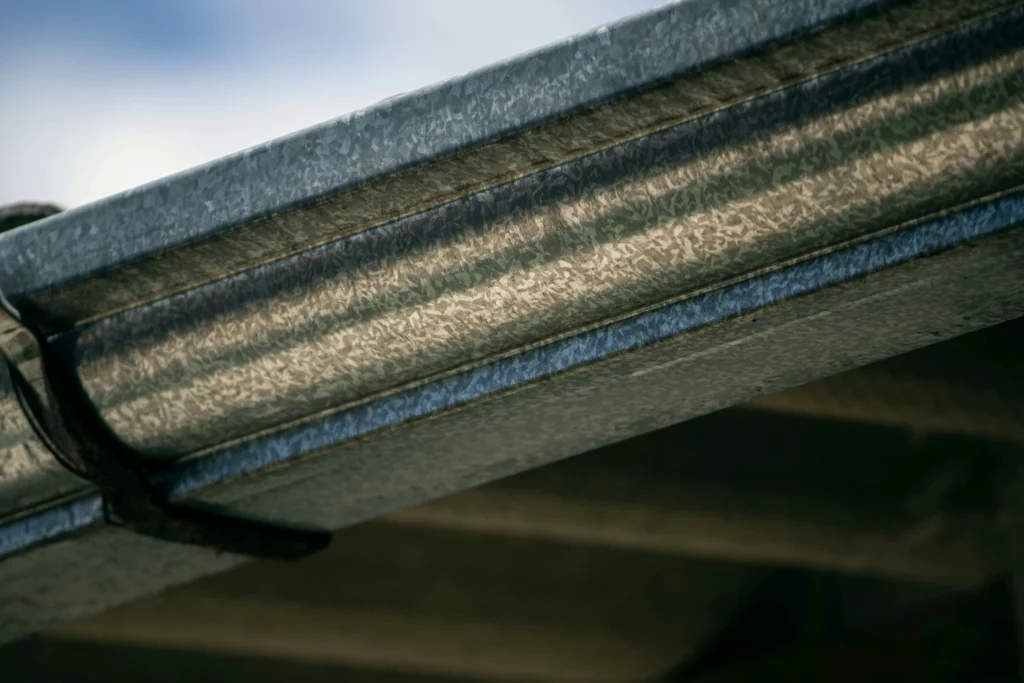 The underside of a clean gutter showing the impact a gutter cleaning business can have.