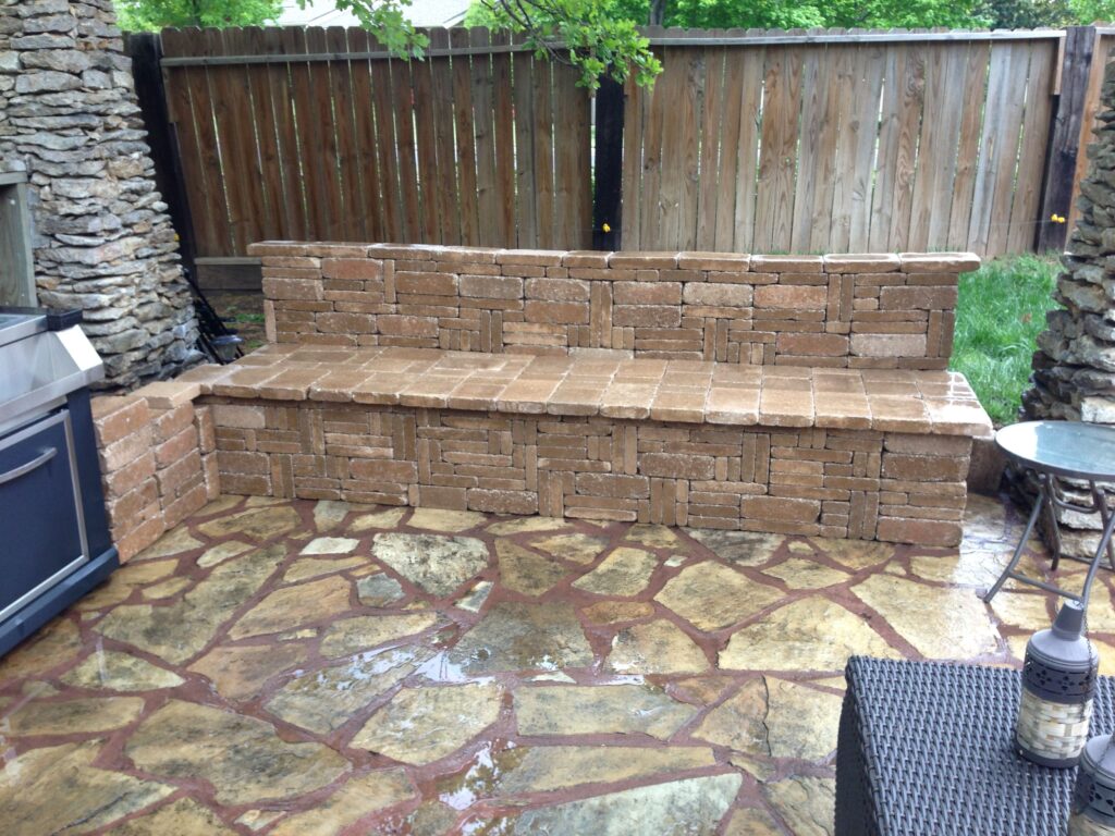 A photo of freshly cleaned stone patio pavers in an outdoor kitchen area.