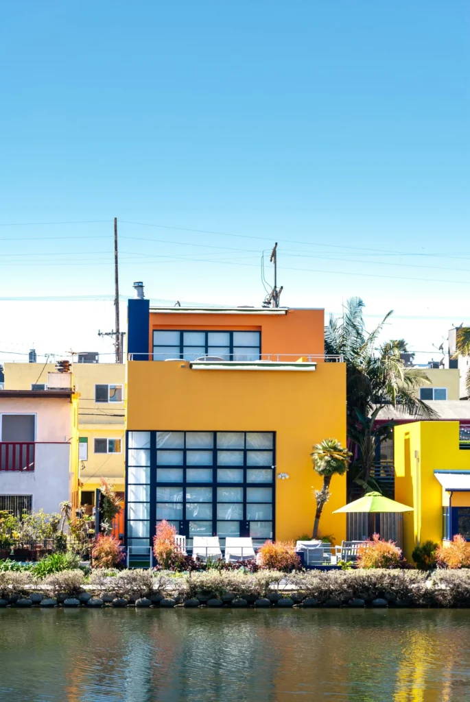 House Facade Styles - a modern and colorful house facade with the lower level painted yellow and the second story painted orange.