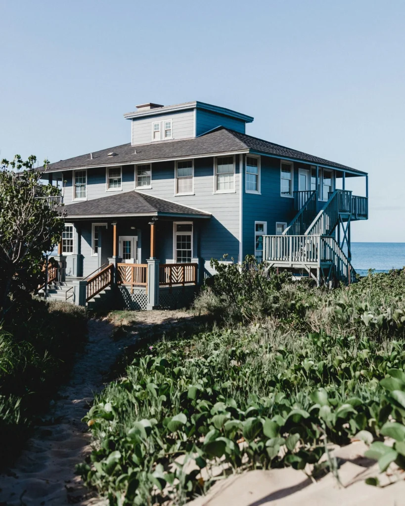 House Facade Styles - a coastal style house facade with blue grey siding by the ocean.