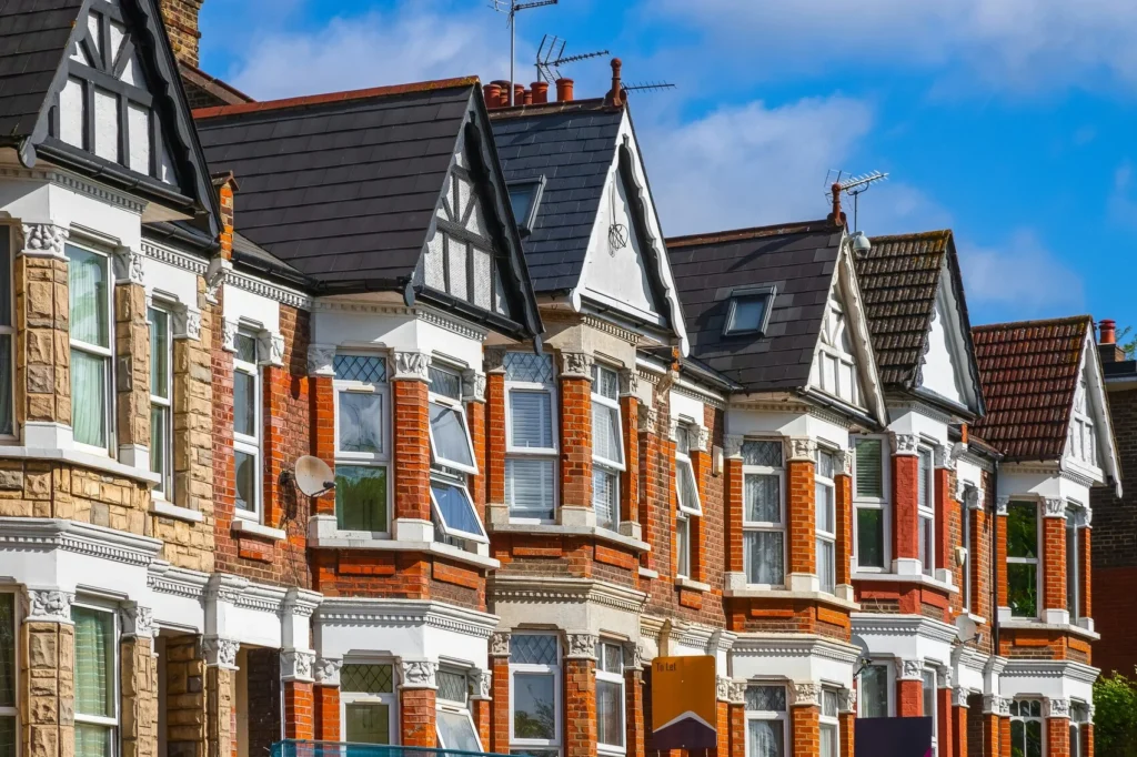 House Facade Styles - a row of brick house facades with a blue sky backround.