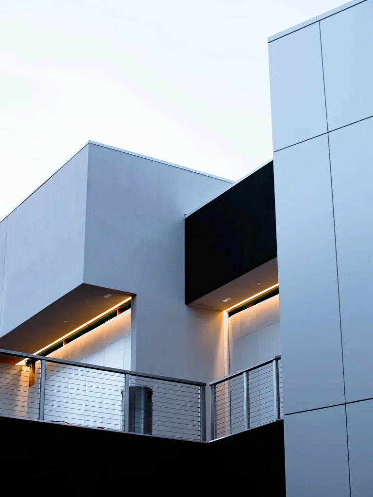 House Facade Styles - a sleek grey house exterior with under lighting.