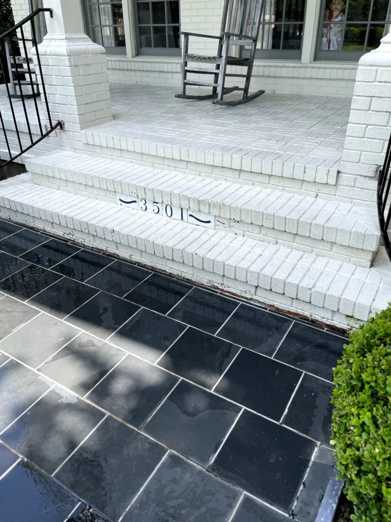 Clean tiles on an entry way showing the results of a pressure washing before and after.