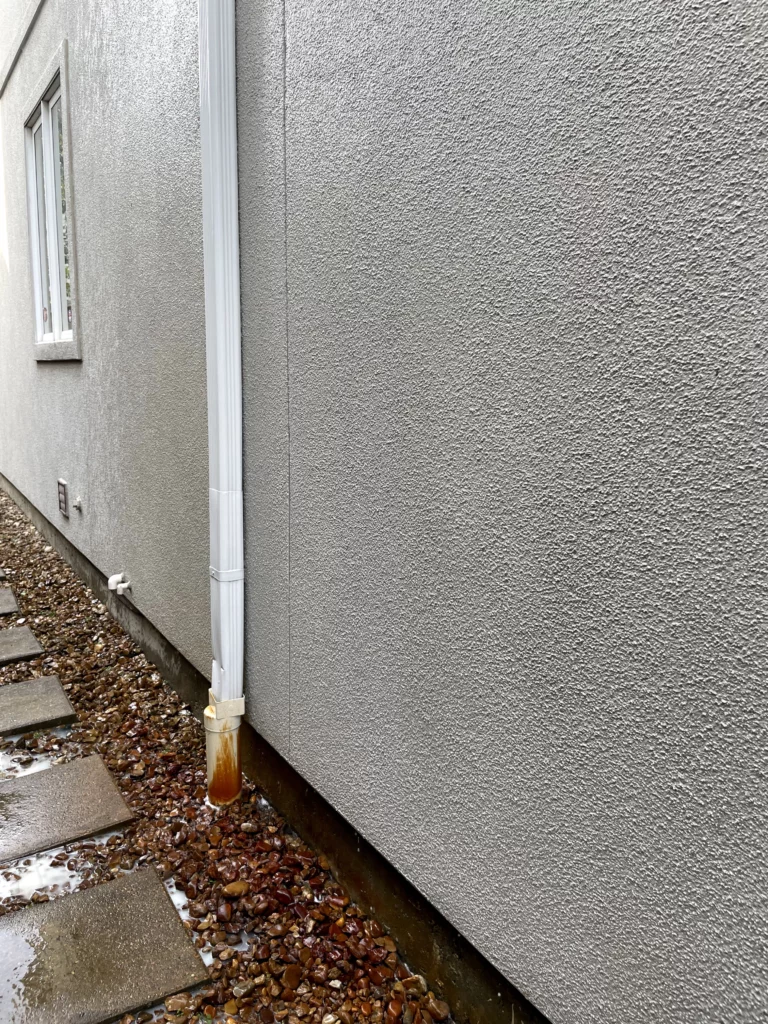 The clean white siding of a house after a pressure washing.