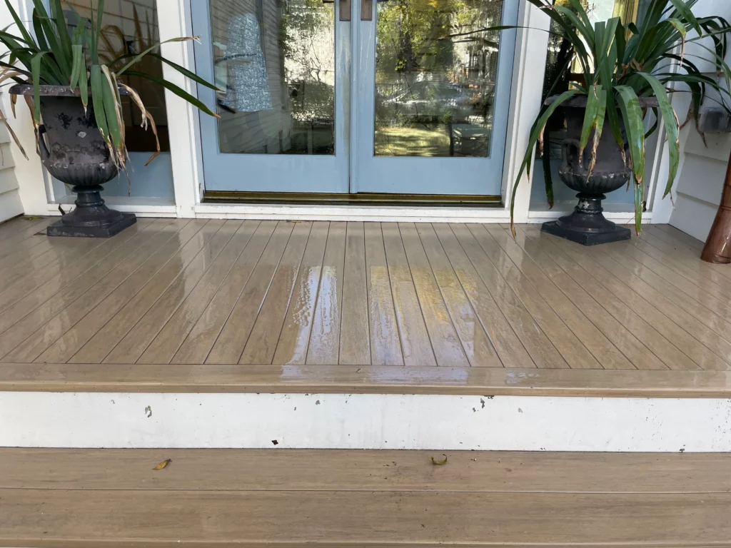A clean wood deck showing the results of pressure washing before and after.