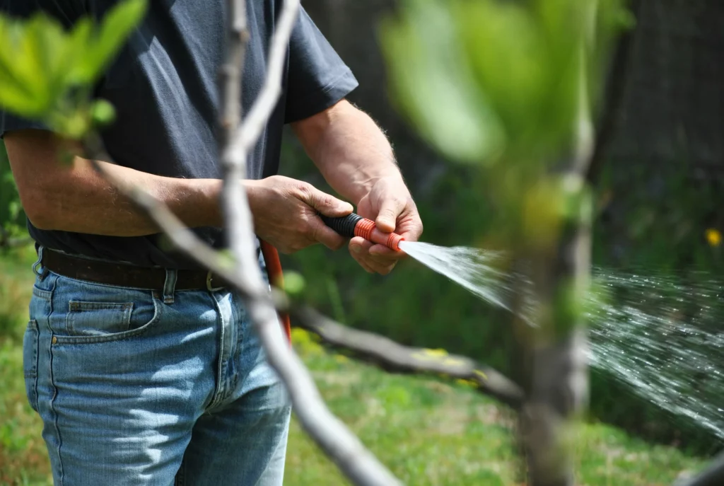 A man adjusting a pressure washer tip.