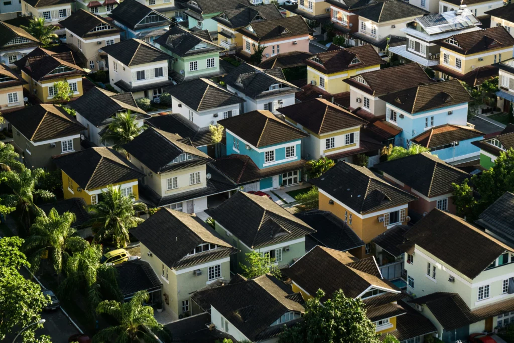 A photo of many houses with dark roofs that show Can You Pressure Wash a Roof.