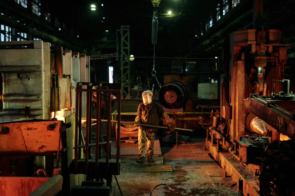 A person working in a factory making glass for glass windows.