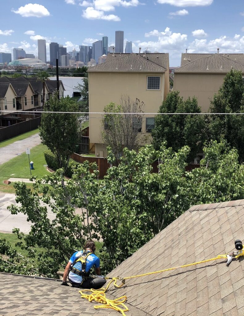 A man from geek window cleaning providing a shingle cleaning services.