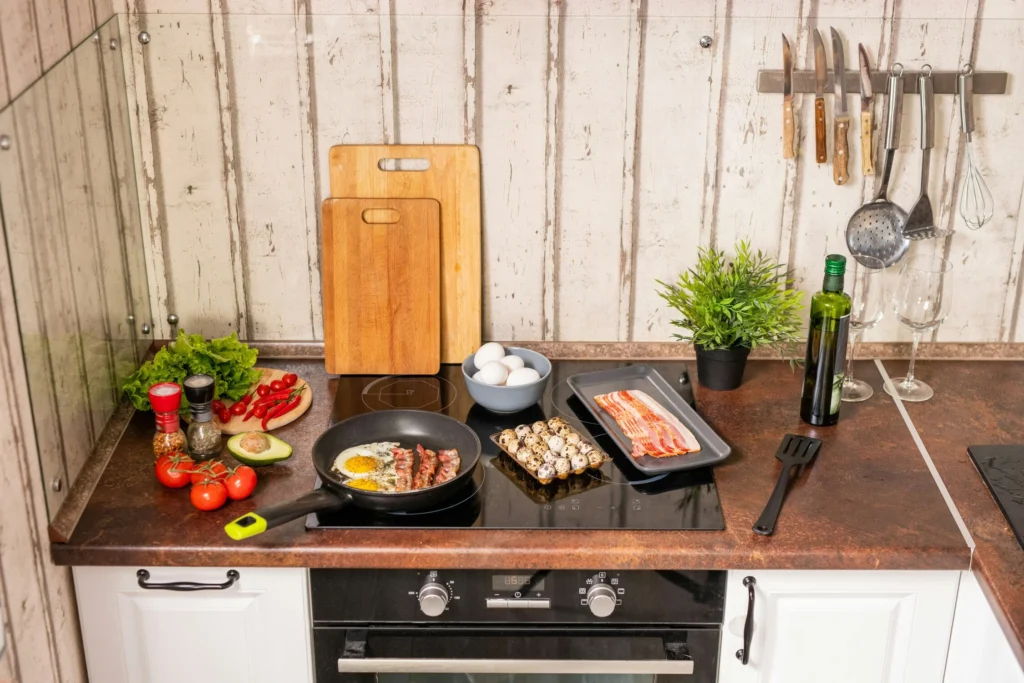 A glass stovetop in a kitchen with food on top.