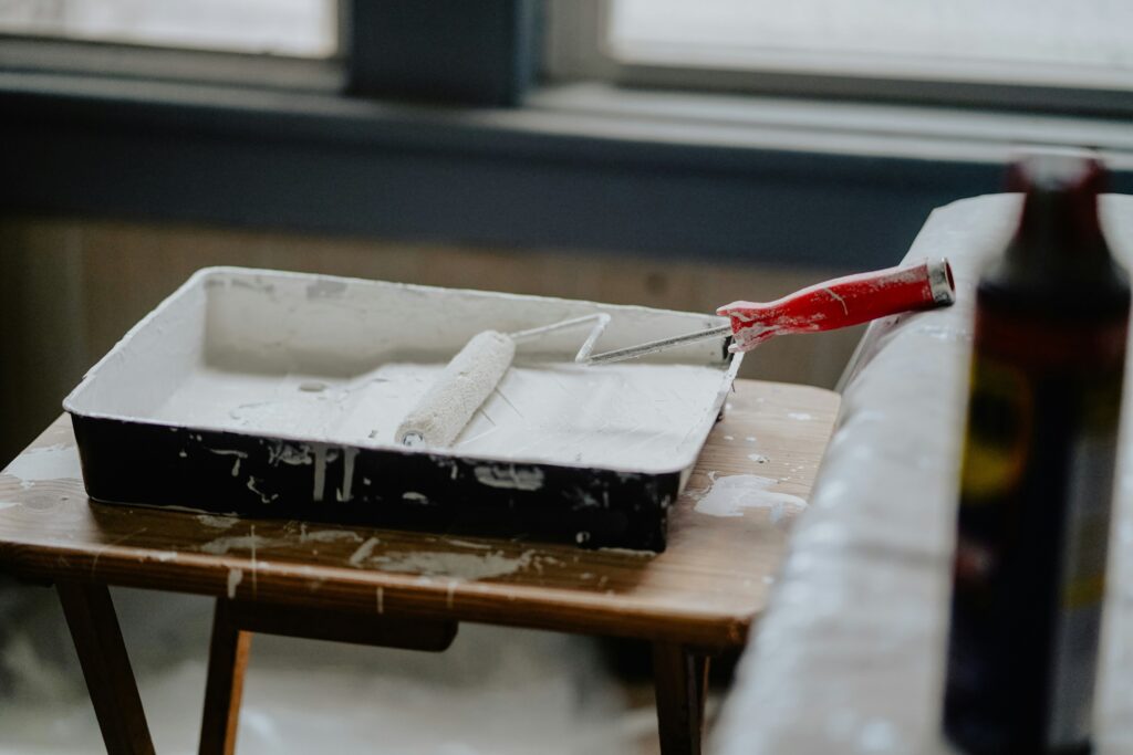 How to Remove Paint from Glass - white paint with a roller in it.