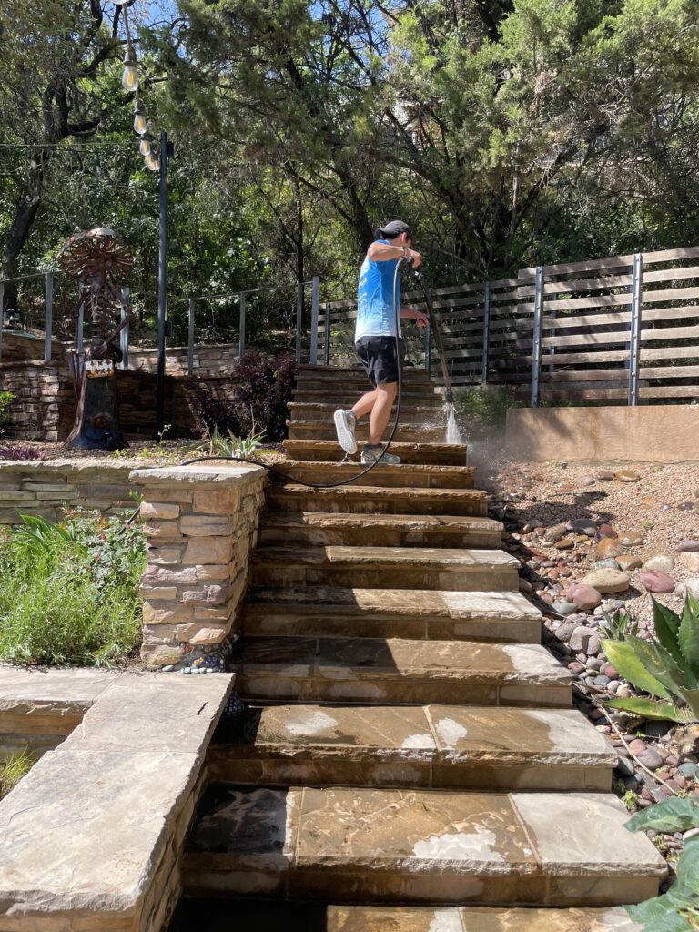 Man curb appeal pressure washing backyard steps