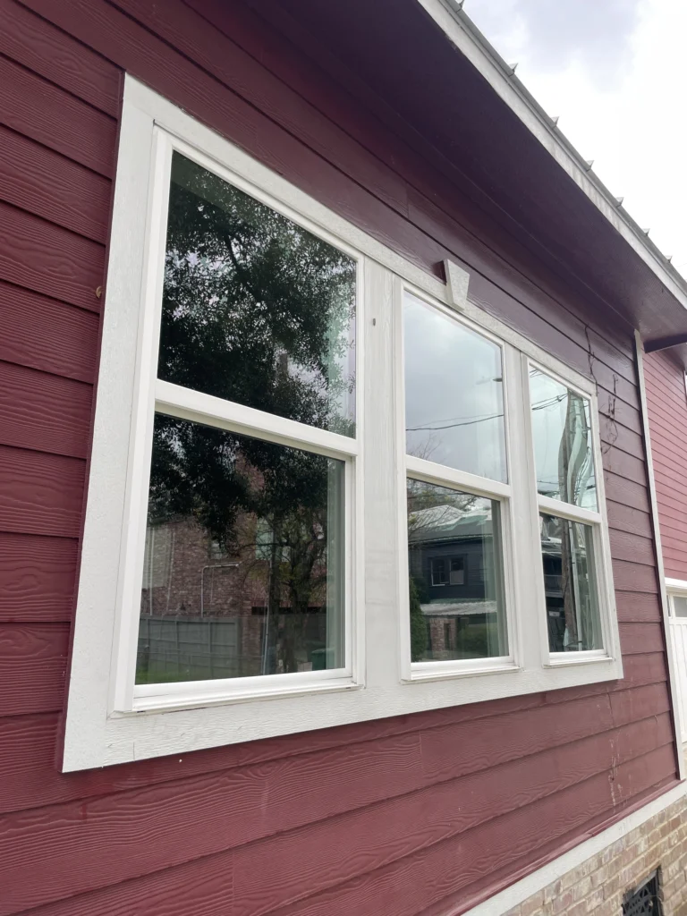 Garage Door Windows - Clean Windows with White Framing on the Siding of a Red Home